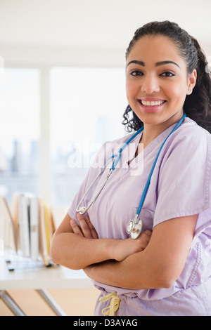 Hispanic nurse smiling in hospital Stock Photo