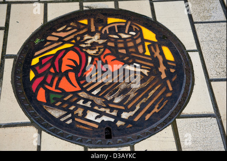 Manhole cover art depicting traditional Japanese washi paper making in the town of Takefu in Fukui Prefecture.