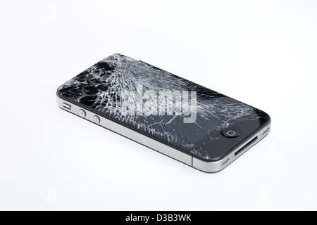 The old Apple iPhone 4 with broken screen, studio shot. Stock Photo