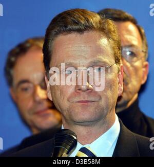 (dpa) - Guido Westerwelle (C), Chairman of the Liberal Party FDP, comments on the disappointing preliminary results after the elections in the FDP headquarters in Berlin, 22 September 2002. In the background FDP Committee member Walter Doering (R). According to estimates the FDP wins only 7.4 per ce