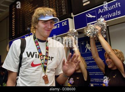 (dpa) - German national basketball player Dirk Nowitzki enjoys the reception of the national team at their arrival at the airport in Frankfurt, 10 September 2002. The German team won bronze during the basketball world championships in Indianapolis. Stock Photo