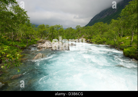 Milky blue glacial water of Briksdal River in Norway Stock Photo