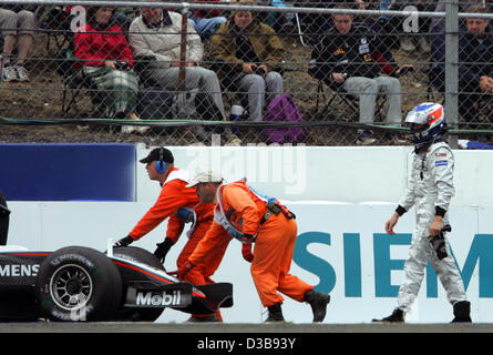 (dpa) - Finnish Formula One driver Kimi Raikkonen (R) of McLaren Mercedes leaves the track during the practice session at the Silverstone circuit, UK, Saturday, 09 July 2005. The British Grand Prix will take place at the Silverstone circuit on Sunday, 10 July. Stock Photo
