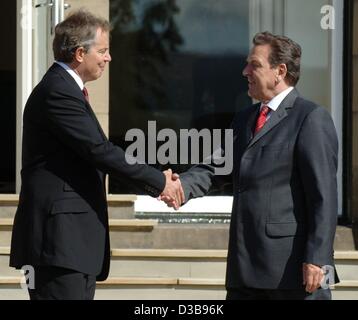 (dpa) - British Prime Minister Tony Blair (L) welcomes German Chancellor Gerhard Schroeder prior to the G8 summit at the Gleneagles Hotel near Edinburgh, UK, 07 July 2005. The leaders of the G8 states deliberate on how to tackle poverty in the world. Stock Photo