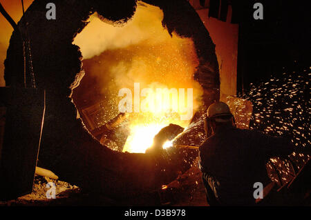 (dpa file) - The picture, dated 30 June 2005, shows an employee of the  the PHB Stahlguss GmbH foundry cleaning a piece of cast steel in St. Ingbert, Germany. PHB is one of the market leaders in steel casting and the turbine industry. Stock Photo