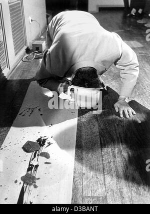(dpa files) - South Korean artist Nam June Paik dips his head into a chamber pot filled with colour and then paints with his head on the paper banner on the floor, during a Fluxus event in Wiesbaden, Germany, 1962. Paik, born on 20 July 1932 in Seoul, South Korea, moved to Germany in 1956 and became