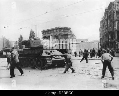 (dpa files) - Demonstrators throw stones at Soviet tanks during the riots against the communist regime in East Berlin, 17 June 1953. The uprising escalated when strikes and a demonstration against unreasonable production quotas were knocked down by Soviet tanks and troops on 17 June. Stock Photo