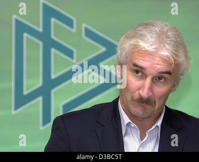 (dpa) - Rudi Voeller, coach of the German national soccer team, sits in front of the logo of the 'Deutscher Fussball Bund-DFB' (German Soccer Association) at a press conference in Neu-Isenburg, Germany, 9 October 2002. Stock Photo