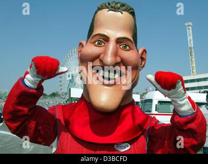 (dpa) - A man wears a huge mask with the face of German formula one champion Michael Schumacher at the racing court in Suzuka, Japan, 13 October 2002. Michael Schumacher wins the Grand Prize of Japan on that day. Stock Photo