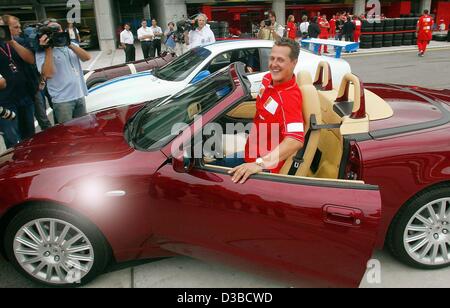 (dpa) - Michael Schumacher, German formula one champion, gets into the new Maserati Spider, on the Motor Speedway in Indianapolis, USA, 26 September 2002. Stock Photo