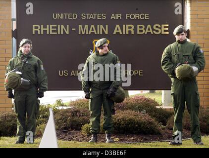 (dpa) - Three German police officers guard the entrance to the Rhein-Main air base of the US army, located just south of the international airport in Frankfurt, 17 January 2003. About 80 demonstrators protesting against US politics on Iraq and against a war in Iraq were blocking the area by sitting 