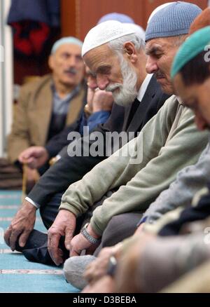 (dpa) - Turks have gathered for the Friday prayer in a mosque in Berlin-Kreuzberg, 10 January 2003. For Friday prayers it is compulsary to attend a service in a mosque, whereas the five daily prayers can be performed anywhere. It is written down in the Koran, sura 62, verse 9: 'O you who believe, wh Stock Photo