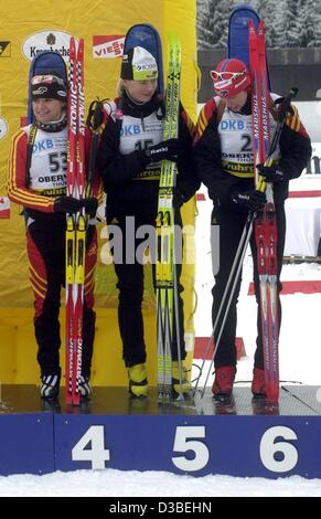 (dpa) - German biathlete Andrea Henkel (L) wins fourth place at the 7.5 km sprint of the Women's Biathlon World Cup in Oberhof, Germany, 8 January 2003. Next to her stands fifth-placed Katrin Apel (C) from Germany and fellow countrywoman Kati Wilhelm (sixth place, R). Stock Photo