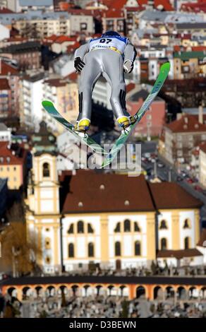 (dpa) - Polish ski jumper Adam Malysz soars through the air during training for the 51st Four Hill Tournament with a beautiful view of the Wilten basilica in Innsbruck, Austria, 3 January 2003. Stock Photo