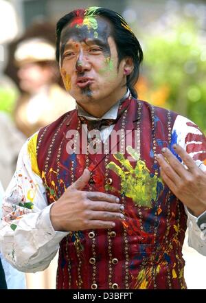 (dpa) - Hong Kong-born actor Jackie Chan alias Passepartout wears a paint-covered suit during the shooting of a remake of 'Around the World in 80 Days' in Goerlitz, eastern Germany, 24 June 2003. Chan's 100-million-dollar fantasy adventure is being filmed at Babelsberg studios. The town of Goerlitz  Stock Photo