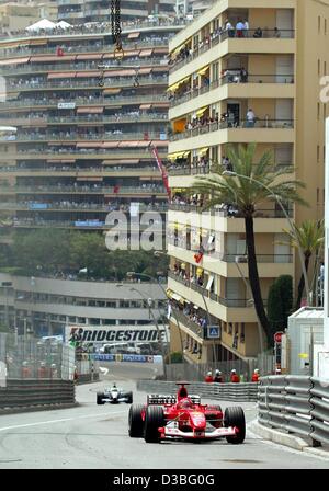(dpa) - German formula one pilot Michael Schumacher (Ferrari) leads ahead of his brother Ralf (BMW Williams) during the Grand Prix of Monaco in Monte Carlo, 1 June 2003. Michael finishes third, Ralf fourth.