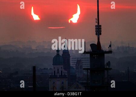 (dpa) - The sky turns red as the moon partially covers the rising sun around five o'clock in the morning in Munich, Germany, 31 May 2003. This is the first solar eclipse since 1999, but contrary to then it was only a penumbral eclipse not a total eclipse. In many places the natural phenomena could n Stock Photo