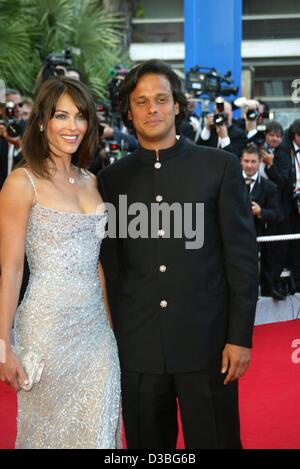 (dpa) - British actress and model Elizabeth Hurley arrives with her new boyfriend Arun Nayer, the General Manager of the Indian textile dynasty Tijarat Impex Pvt. Ltd. in Bombay, to the closing ceremony of the 56th Cannes film festival in Cannes, France, 25 May 2003. Stock Photo