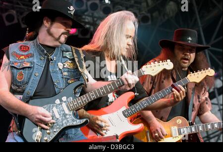 (dpa) -  The three guitarists of the US rock band Lynyrd Skynyrd, (from L)  Hughey Thomasson, Ricky Medlocke and Gary Rossington perform at an open air concert during the 'Hessentag' in Bad Arolsen, Germany, 18 June 2003.  More than 15,000 fans enjoyed a terrific musical trip back to 70s in the loca Stock Photo