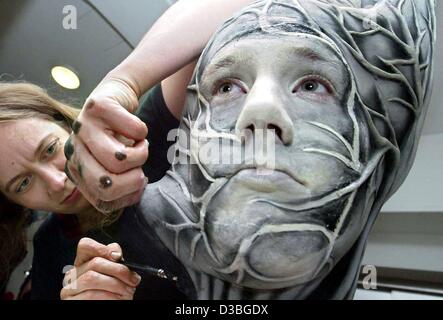 (dpa) - A make-up artist puts the finishing touches to an imaginative mask on an actor at the theatre in Nuremberg, Germany, 20 May 2003. After their apprenticeship the make up artist pupils in Germany have to take an official examination, which allows them to work in their job. Stock Photo