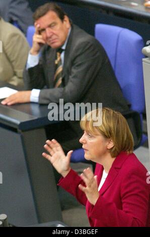 (dpa) - Angela Merkel, Chairmwoman of the German opposition party CDU, is gesturing during her speech in the Bundestag (lower house of German parliament), while Chancellor Schroeder is listening, Berlin, 18 June 2003. The governing coalition of Social Democrats and Greens wants to reach an agreement Stock Photo