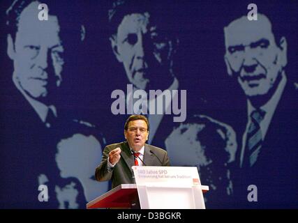 (dpa) - German Chancellor Gerhard Schroeder speaks in front of the portraits of former social democratic chancellors (from L:) Willi Brandt, Helmut Schmidt and himself, in the tempodrome in Berlin, 23 May 2003. The German social democratic party SPD celebrates its 140th anniversary this year. The SP