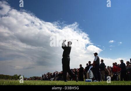 (dpa) - US golf star Tiger Woods swings his golf club during a practise run in front of spectators just before the start of the Deutsche Bank - SAP Open golf tournament on the golf course in Gut Kaden, Germany, 15 May 2003. The tournament will last until 18 May 2003 with an allocated prize money of  Stock Photo