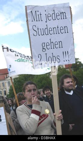 (dpa) - A young woman blows a whistle and carries a poster, which reads 'With every student two more jobs are lost', in protest of the planned cutbacks in higher education at the technical college in Magdeburg, Germany, 15 May 2003. The German state of Saxony-Anhalt plans to cutback more than 4,000  Stock Photo