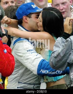 (dpa) - His wife Connie congratulates Colombian formula one pilot Juan Pablo Montoya (BMW Williams) after he won the Grand Prix of Monaco in Monte Carlo, 1 June 2003. Montoya finishes first and celebrates the first victory of BMW Williams this season. Stock Photo