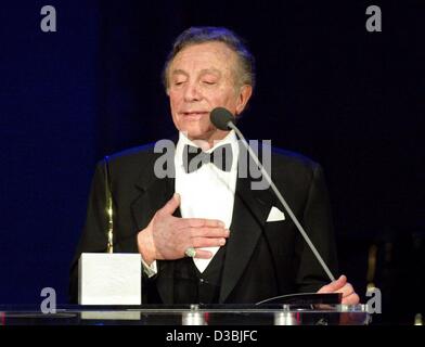 (dpa) - 76-year-old US singer Al Martino stands in front of a microphone and speaks during the 'Radio Regenbogen Awards' (radio rainbow awards) in Mannheim, Germany, 28 March 2003. Martino was awarded the 'Radio Regenbogen Award' in the category 'Lifetime Entertainment 2002'. Around 1,500 guest were Stock Photo