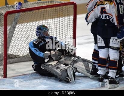 (dpa) - Hamburg's goal keeper Boris Rousson sits on the ice after Berlin scored a goal during the DEL (German Ice Hockey League) match Berlin Eisbaeren against Hamburg Freezers, Berlin, Germany, 21 March 2003. Berlin wins the fifth game of the playoff quarter final 4-0. Berlin has qualified for the  Stock Photo