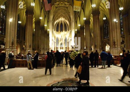 (dpa) - Visitors walk around St. Patrick's Cathedral in New York, 15 Febuary 2003. This massive cathedral, situated across from Rockefeller Center on Fifth Avenue, is the largest Catholic cathedral in the United States. With its two soaring 330-foot spires, it is also one of the city's most spectacu Stock Photo