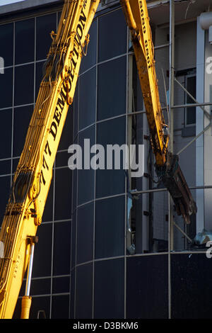 Bournemouth, UK 15 February 2013. The bulldozers start tearing down the glass front of one of the most hated buildings in the UK, the Imax complex building on Bournemouth seafront. Once demolished, the site will be turned into an open-air events arena, ready for the summer season. Stock Photo