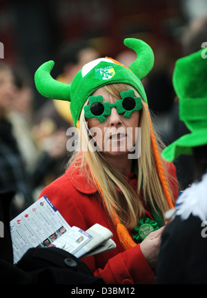 A woman is seen wearing a hat on St Patrick's Day the Cheltenham Festival, an annual horse racing fixture in southwest England Stock Photo