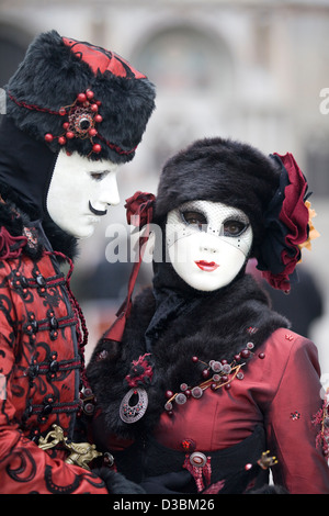 Couple dressed in Traditional venetian Costume wearing a Bauta Mask for the Venice Carnival Venice Italy Stock Photo