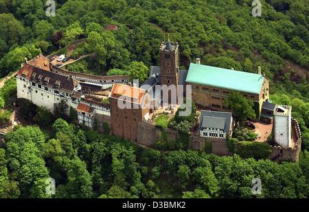 (dpa) - A view of Wartburg Castle located above the town of Eisenach, Germany, 16 May 2003. Although it has retained some original sections from the feudal period, it acquired its form during the 19th century reconstitution. It was during his exile at Wartburg Castle that Martin Luther translated th Stock Photo