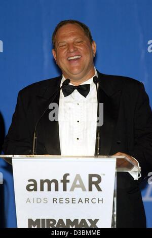 (dpa) - Hollywood producer Harvey Weinstein, Chairman of the film company Miramax, speaks during the auction at the AMFAR (American Foundation for Aids Research) charity gala at the Restaurant Moulin de Mougins near Cannes, France, 22 May 2003. Stock Photo