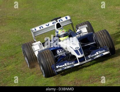 (dpa) - German formula one pilot Ralf Schumacher of the BMW-Williams team steers his race car across the lawn during the free training on the Albert Park race track in Melbourne, 8 March 2003. Stock Photo