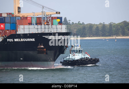 POS Melbourne Container Ship arriving in Port Botany with the help of local harbour tugboats Sydney Australia Stock Photo