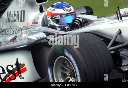 (dpa) - Finnish formula one pilot Kimi Raeikkoenen of McLaren Mercedes drives through a curve during the free training on the formula one race track in Suzuka, Japan, 10 October 2003. The 16th and final round of the Formula One World Championships will be held in Suzuka, about 300 km southwest of To Stock Photo