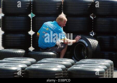 (dpa) - A Renault mechanic checks the air pressure of the tyres for the for the formula one cars, on the race track in Suzuka, Japan, 9 October 2003. The decisive race of the formula one world championship will take place in Suzuka, around 300 kilometres south of Tokyo on 12 October 2003. Stock Photo