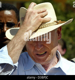 (dpa) - German President Horst Koehler adjusts his hat during a visit at German actor Karlheinz Boehm's training centre of the aid organization 'Menschen fuer Menschen' (people for people) in Harar, Ethiopia, 14 December 2004. As part of his tour of Africa, Koehler is in Ethiopia for five days. Stock Photo