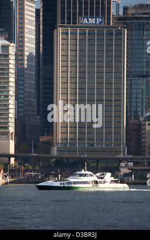 Sydney Harbour Ferry FastCat passing in front of the AMP Building on Alfred Street Circular Quay - Australia's first skyscraper Stock Photo