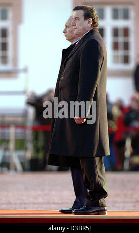 (dpa) - Russian President Vladimir Putin and German Chancellor Gerhard Schroeder (front) inspect the honour guard at Gottorf Castle near Schleswig, northern Germany, on Tuesday, 21 December 2004. Putin is on a two-day visit to Germany for talks focussing on collaborations in the economic sector and  Stock Photo