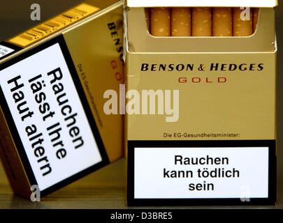 (dpa) - The close up shows the front and back side of a Benson & Hedges cigarette box with new, more noticeable caution marks saying 'Rauchen kann tödlich sein' (Smoking can kill) and 'Rauchen laesst ihre Haut altern' (Smoking lets your skin grow old) in Solingen, Germany, 29 September 2003. The new Stock Photo