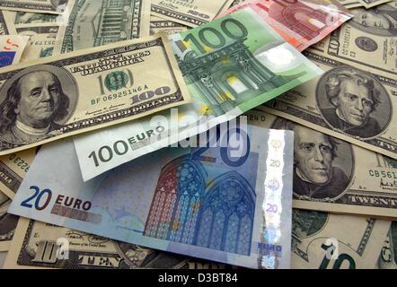 (dpa) - Euro banknotes lie among a pile of dollars in Berlin, 25 August 2003. Stock Photo