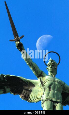 The statue of the archangel Michael with a sword in his hand above the ...