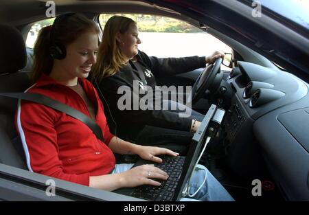 (dpa) - The two interns Meike Schmidt (L) and Manuela Mueller drive a Ford Fiesta and test the inside noise volume of the car at the testing ground at the development centre of the Ford factury in Cologne, Germany, 3 September 2003. The two young women are participating in the 'Try-Ing' internship p Stock Photo