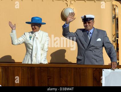 (dpa) - Queen Margrethe II of Denmark and her husband Prince Henrik wave from the deck of the royal yacht Dannebrog upon their arrival in Luebeck, Germany, 5 September 2003. Luebeck is the first stop of the Danish royal couple who are on an official visit to Germany. Stock Photo