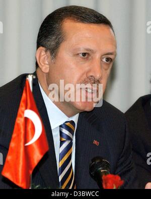 (dpa) - Turkish Prime Minister Recep Tayyip Erdogan sits next to a Turkish flag as he visits a Turkish neighbourhood club in Berlin, 2 September 2003. Stock Photo